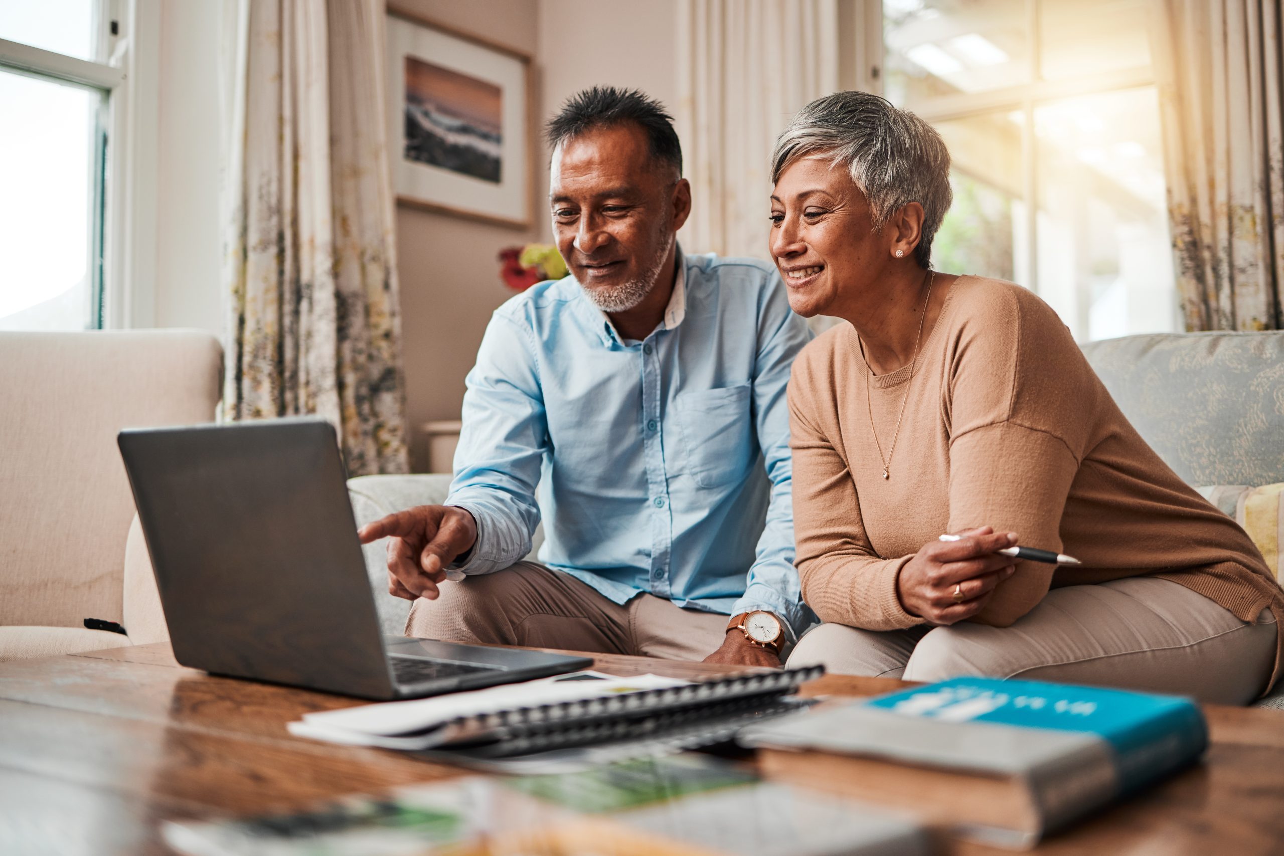 An older man and woman look over their personal finance financial planning